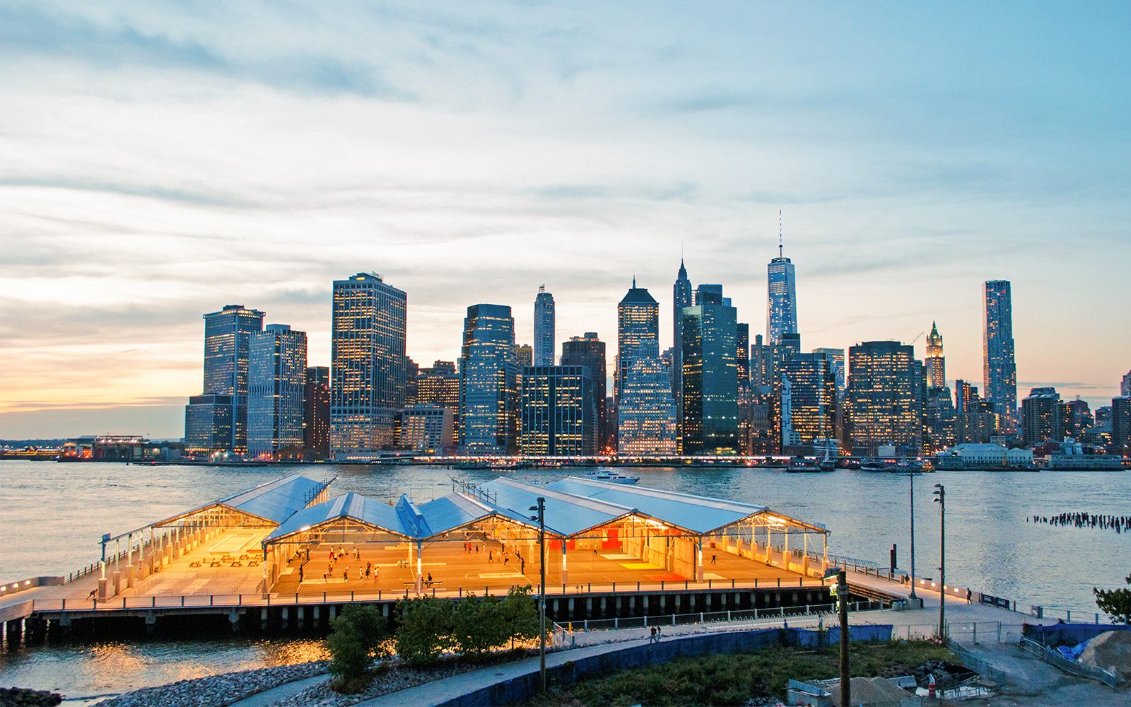 Brooklyn Heights Promenade overlooking Manhattan skyline at sunset.
