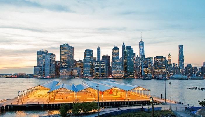 Brooklyn Heights Promenade overlooking Manhattan skyline at sunset.