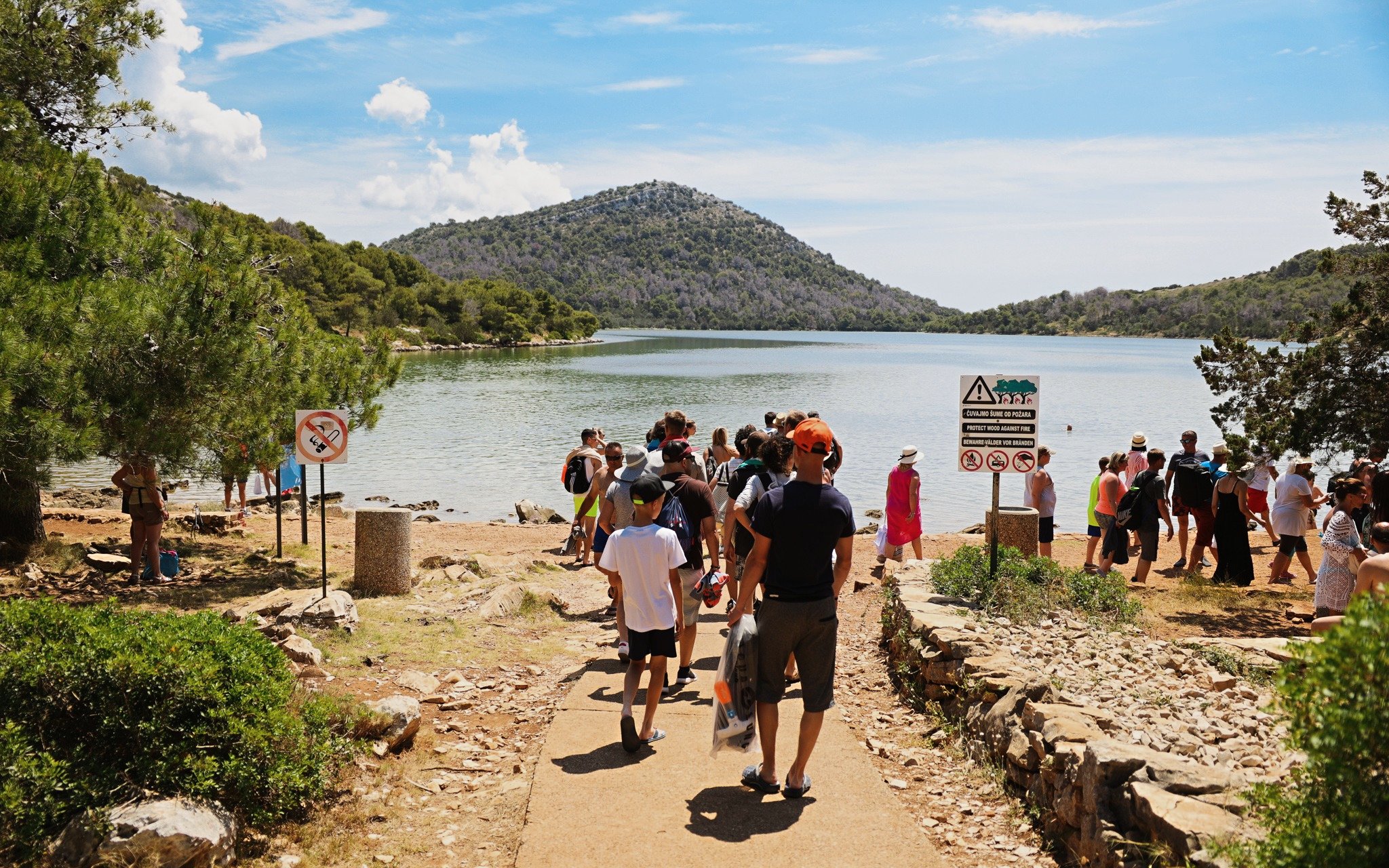 Visitors gathering at Lake Mir in Telašćica Nature Park, Croatia.