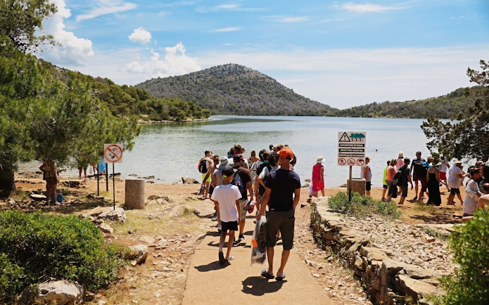 Visitors gathering at Lake Mir in Telašćica Nature Park, Croatia.