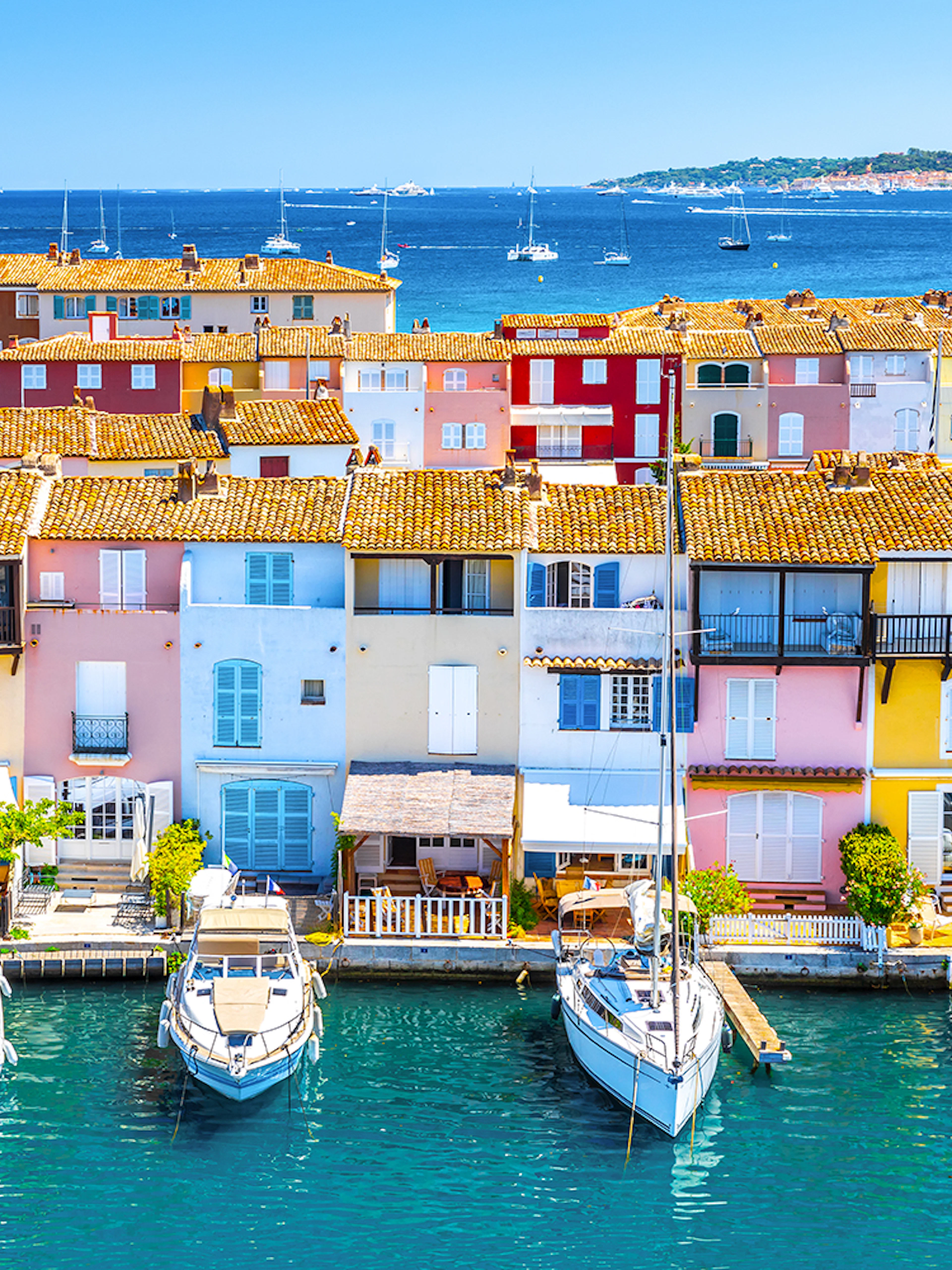 Colorful buildings and boats in Port Grimaud, France, viewed from the water.
