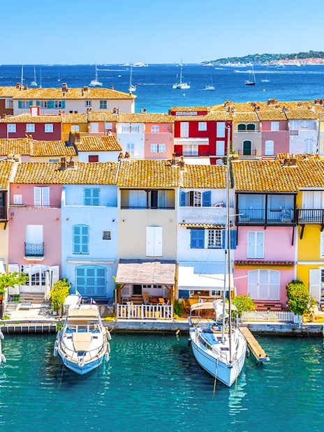 Colorful buildings and boats in Port Grimaud, France, viewed from the water.
