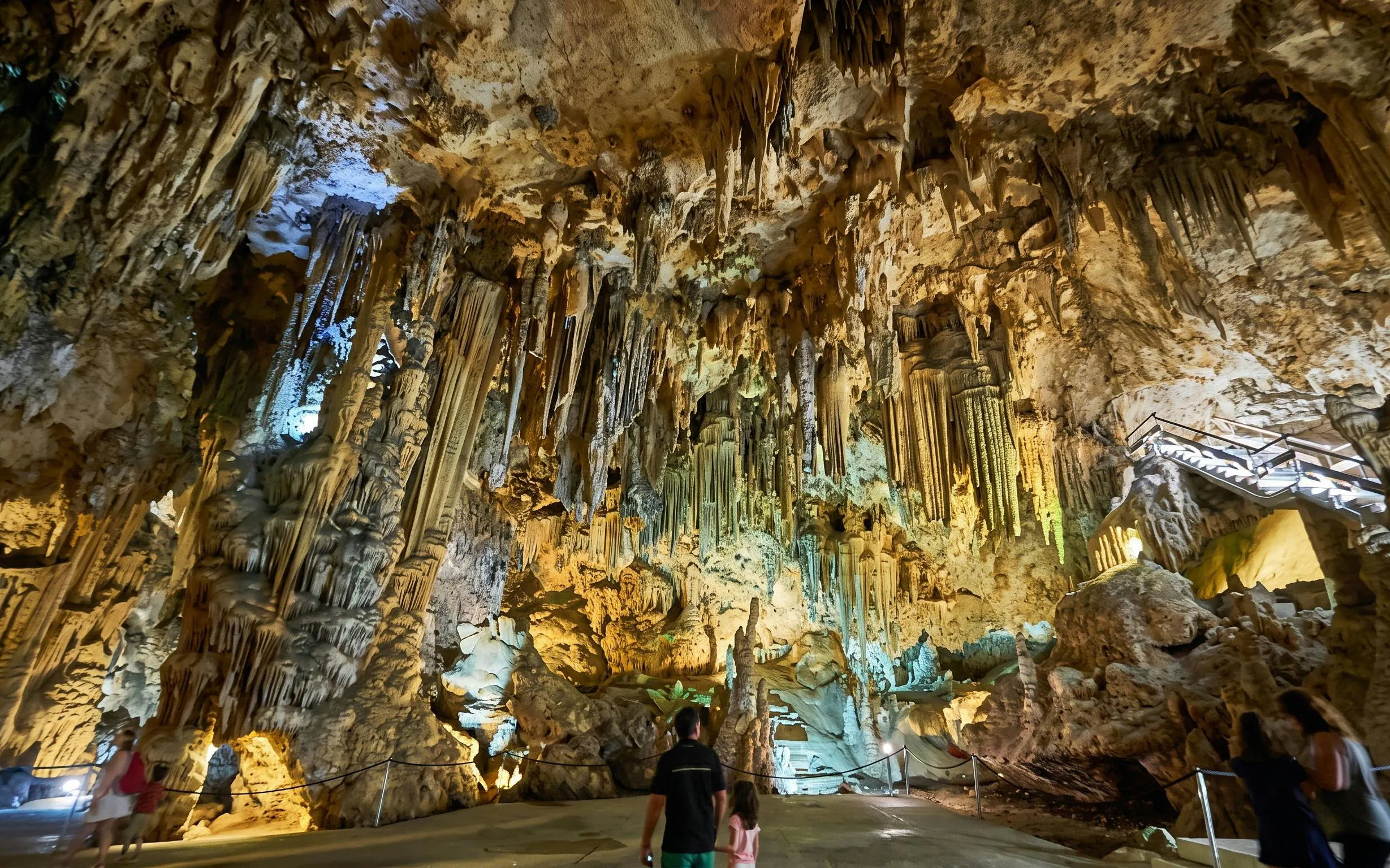 Visitors exploring the stalactites and stalagmites in the Caves of Nerja, Spain.