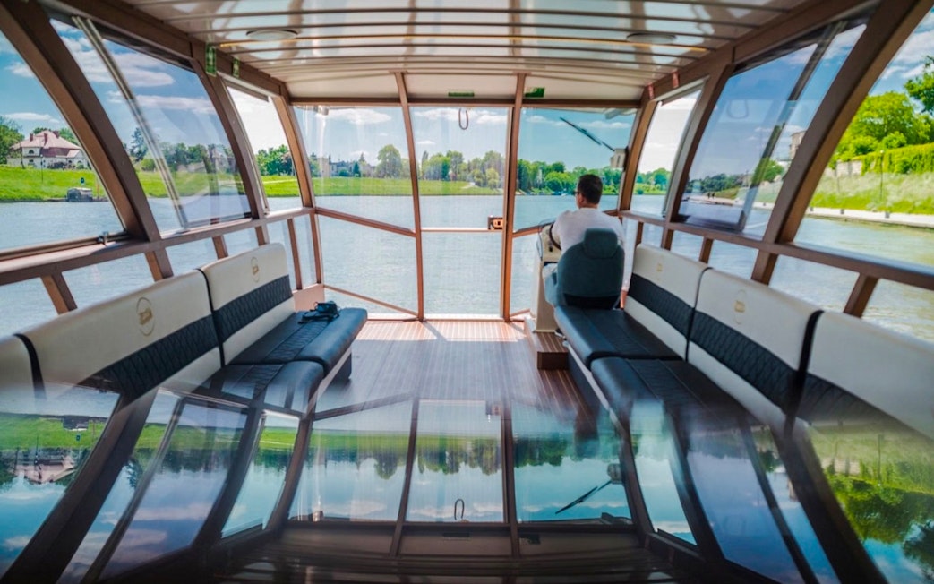Interior view of Vistula River cruise boat with scenic riverbank views.