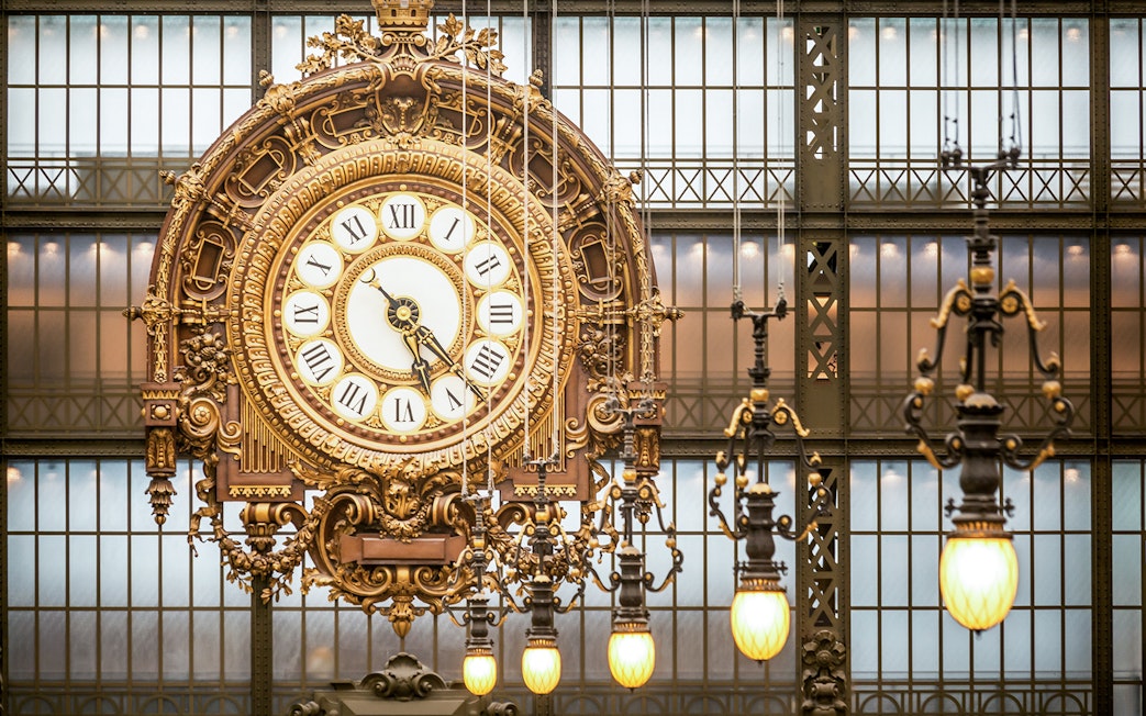 Ornate clock inside Musée d’Orsay during guided tour in Paris.