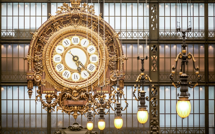 Ornate clock inside Musée d’Orsay during guided tour in Paris.