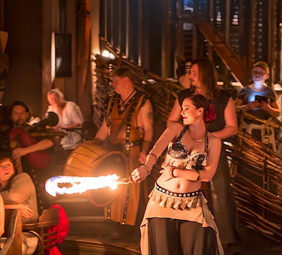 Fire performer entertaining guests at a themed event in Dubai.