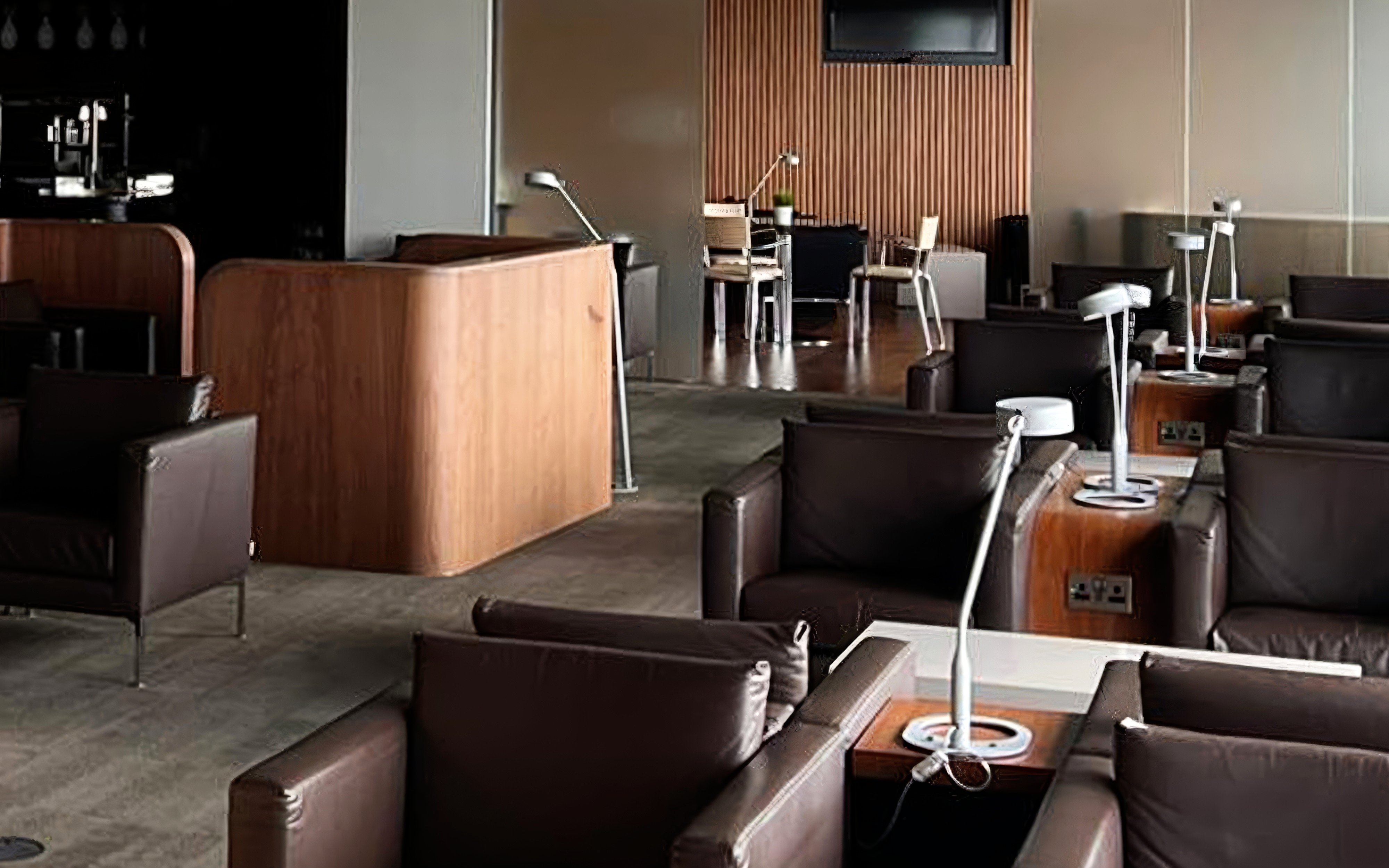 Blush Lounge seating area with leather chairs and tables, Terminal 4, London Heathrow Airport.
