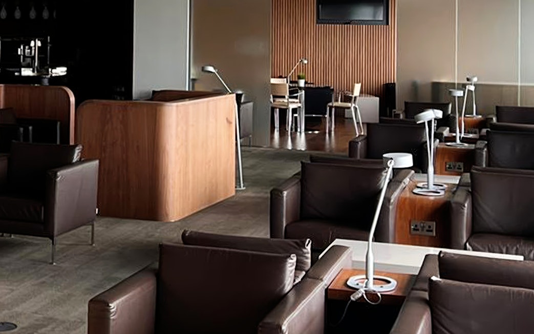 Blush Lounge seating area with leather chairs and tables, Terminal 4, London Heathrow Airport.