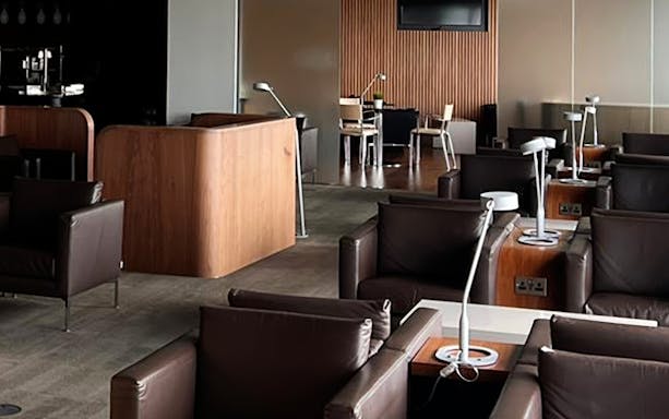 Blush Lounge seating area with leather chairs and tables, Terminal 4, London Heathrow Airport.