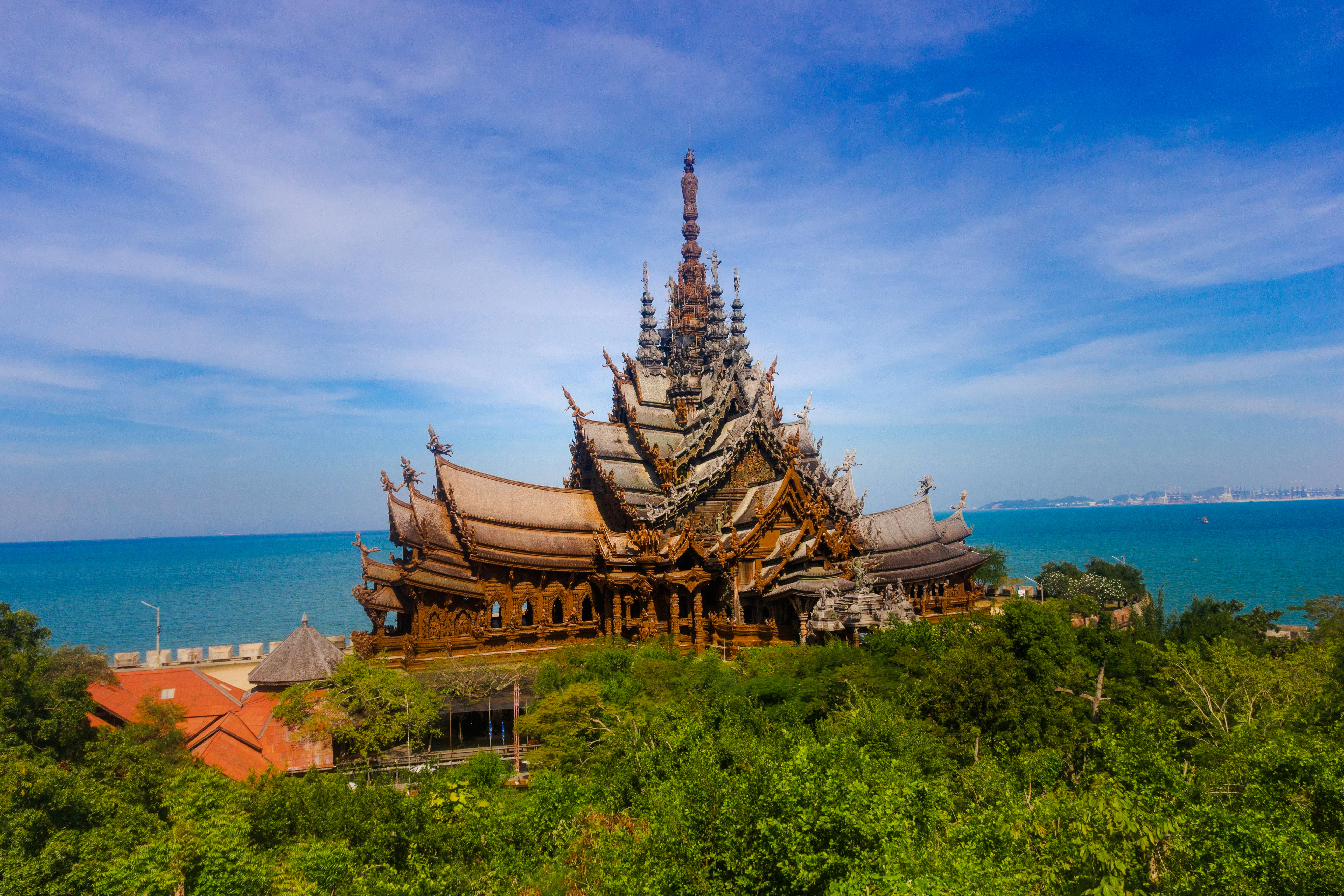 Sanctuary of Truth by the sea in Pattaya, showcasing intricate wooden architecture.