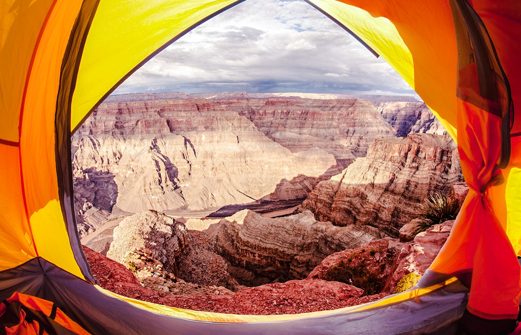 Open tent overlooking the Grand Canyon with a view of the canyon's layered rock formations.