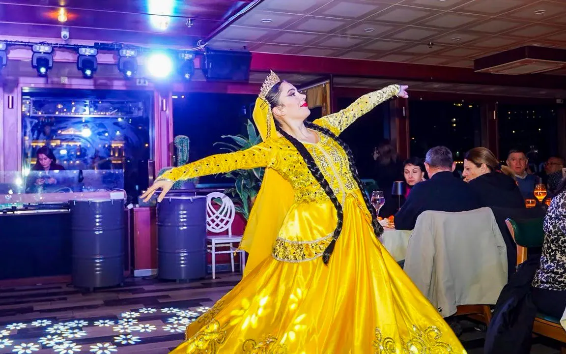 Traditional Turkish folk dancer performing on a night-time dinner cruise.