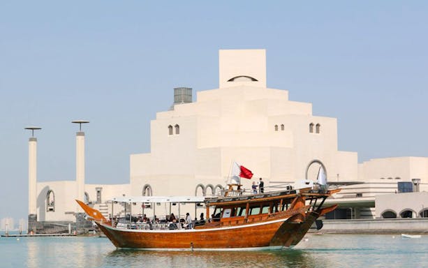 Dhow cruise in front of Museum of Islamic Art in Doha, Qatar.
