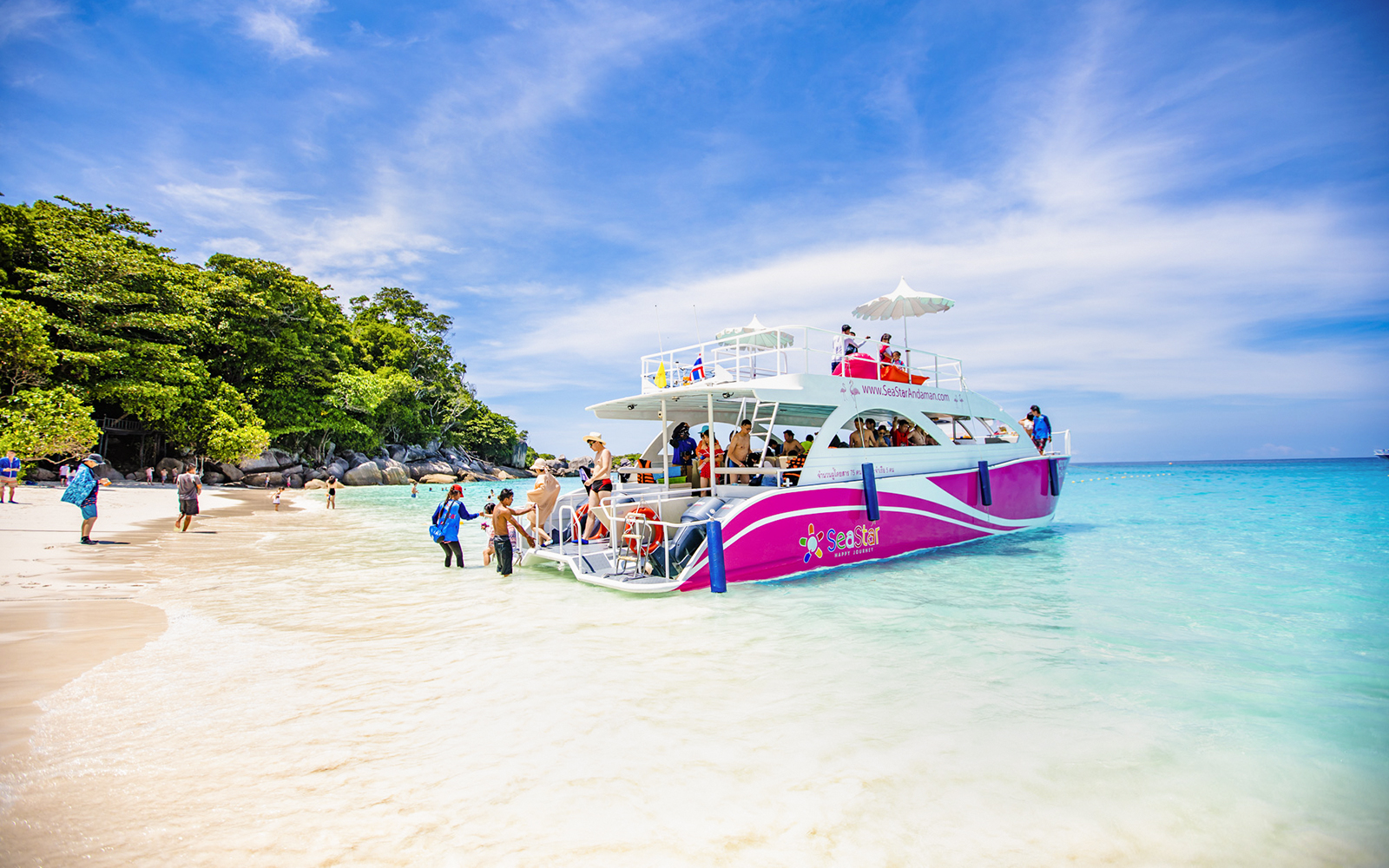 Catamaran docked at Similan Island beach with tourists boarding.