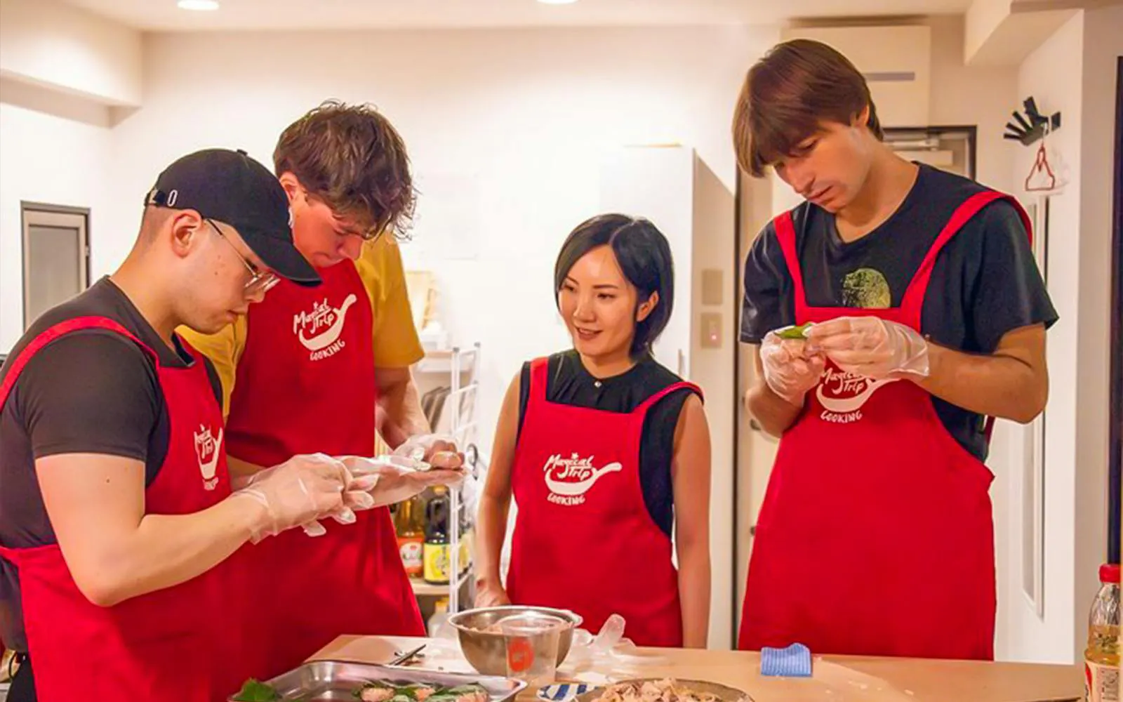 Participants in a Tokyo izakaya-style cooking class preparing ingredients together.