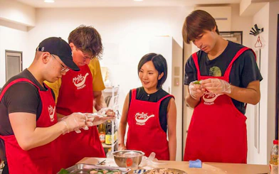 Participants in a Tokyo izakaya-style cooking class preparing ingredients together.