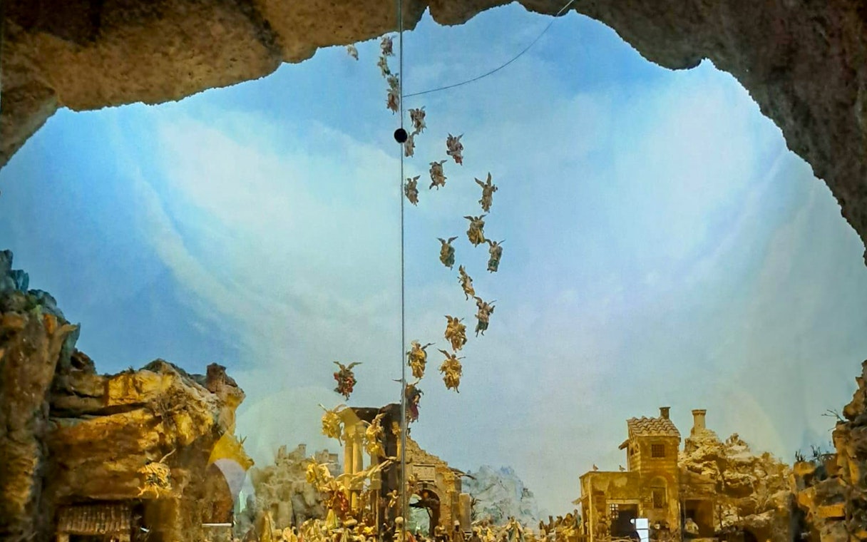 Nativity scene with angels above a village, part of Castel Sant'Elmo and Certosa di San Martino tour in Naples.