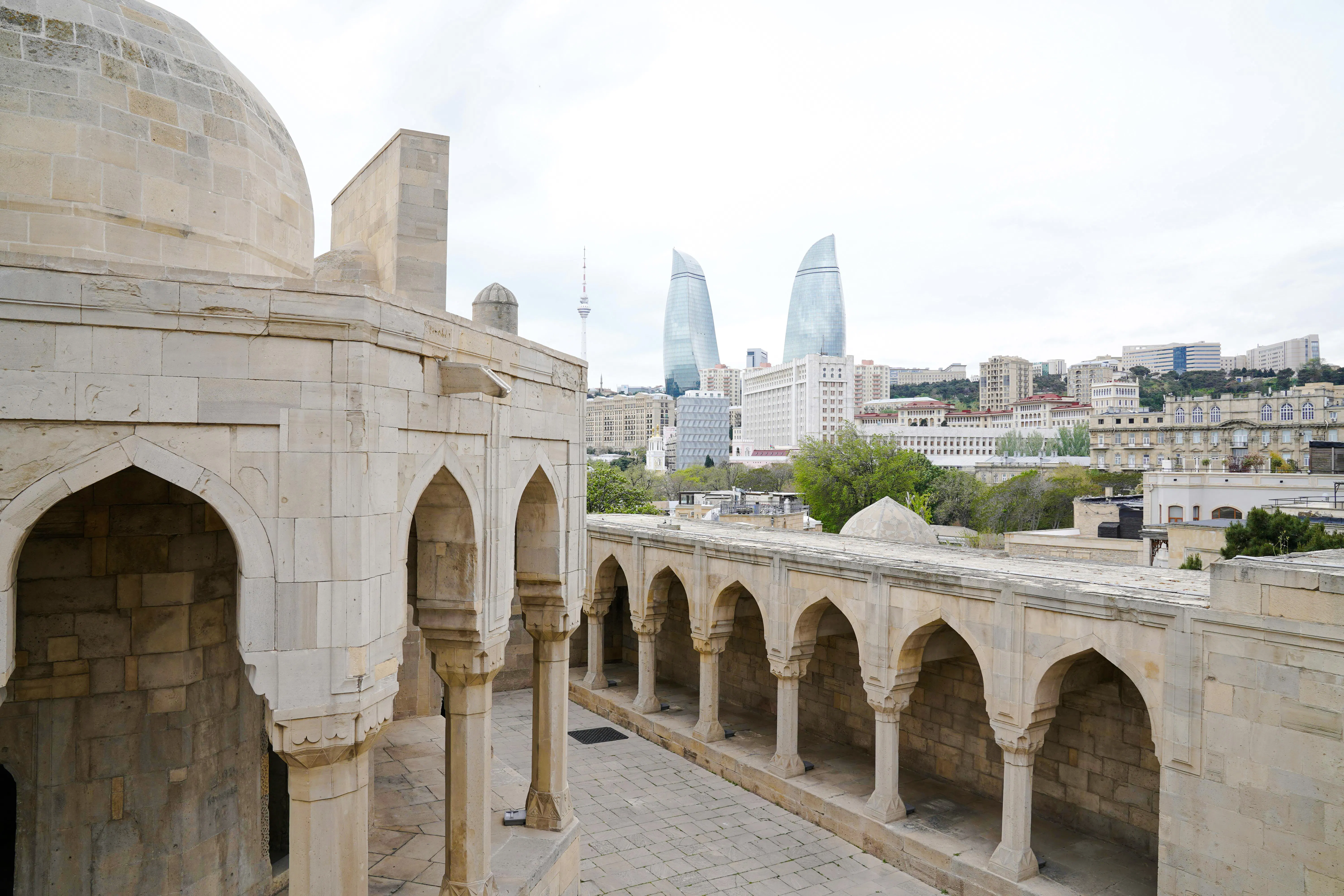 Old city architecture with modern Flame Towers in Baku, Azerbaijan.