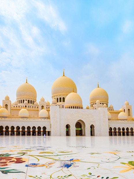 Sheikh Zayed Grand Mosque courtyard in Abu Dhabi with floral marble design.
