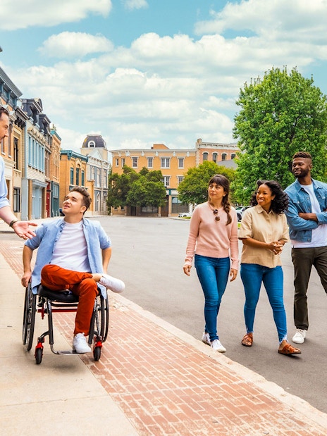 Guide leading a group tour at Warner Bros. Studio, Burbank, with diverse visitors.