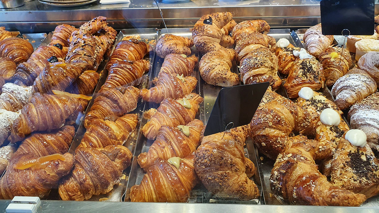 Assorted croissants displayed in a Florence bakery during a food tour.
