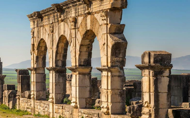 Volubilis Roman ruins with stone arches in Fes, Morocco.