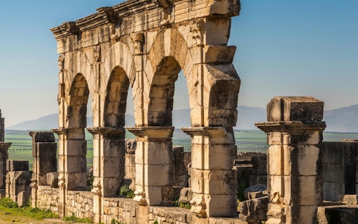 Volubilis Roman ruins with stone arches in Fes, Morocco.