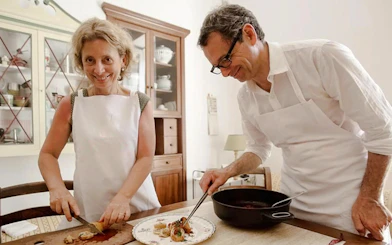 Cooking lesson in Genoa with two people preparing traditional Genoese dishes.