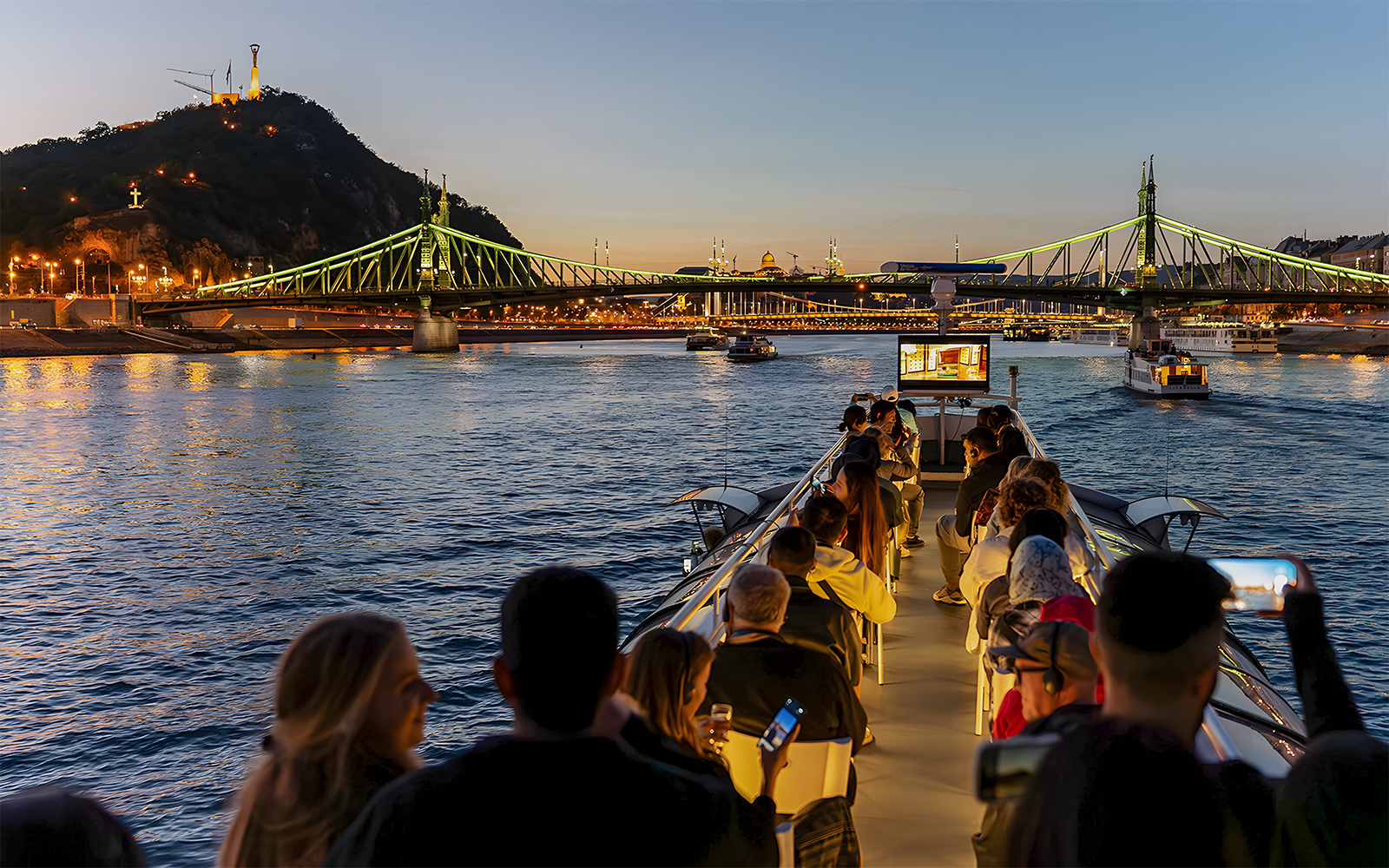 Tourist on Budapest cruise near the Liberty Bridge