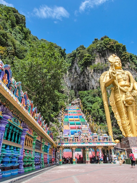 Murugan statue and colorful temple entrance at Batu Caves, Kuala Lumpur.