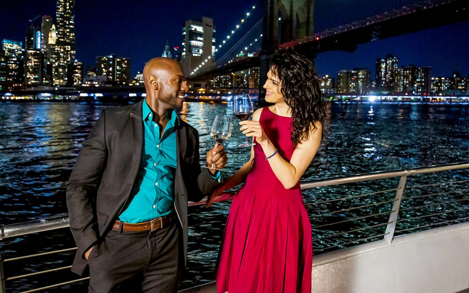 Guests enjoying a luxurious Bateaux New York Premier Dinner Cruise with stunning views of the city skyline at night