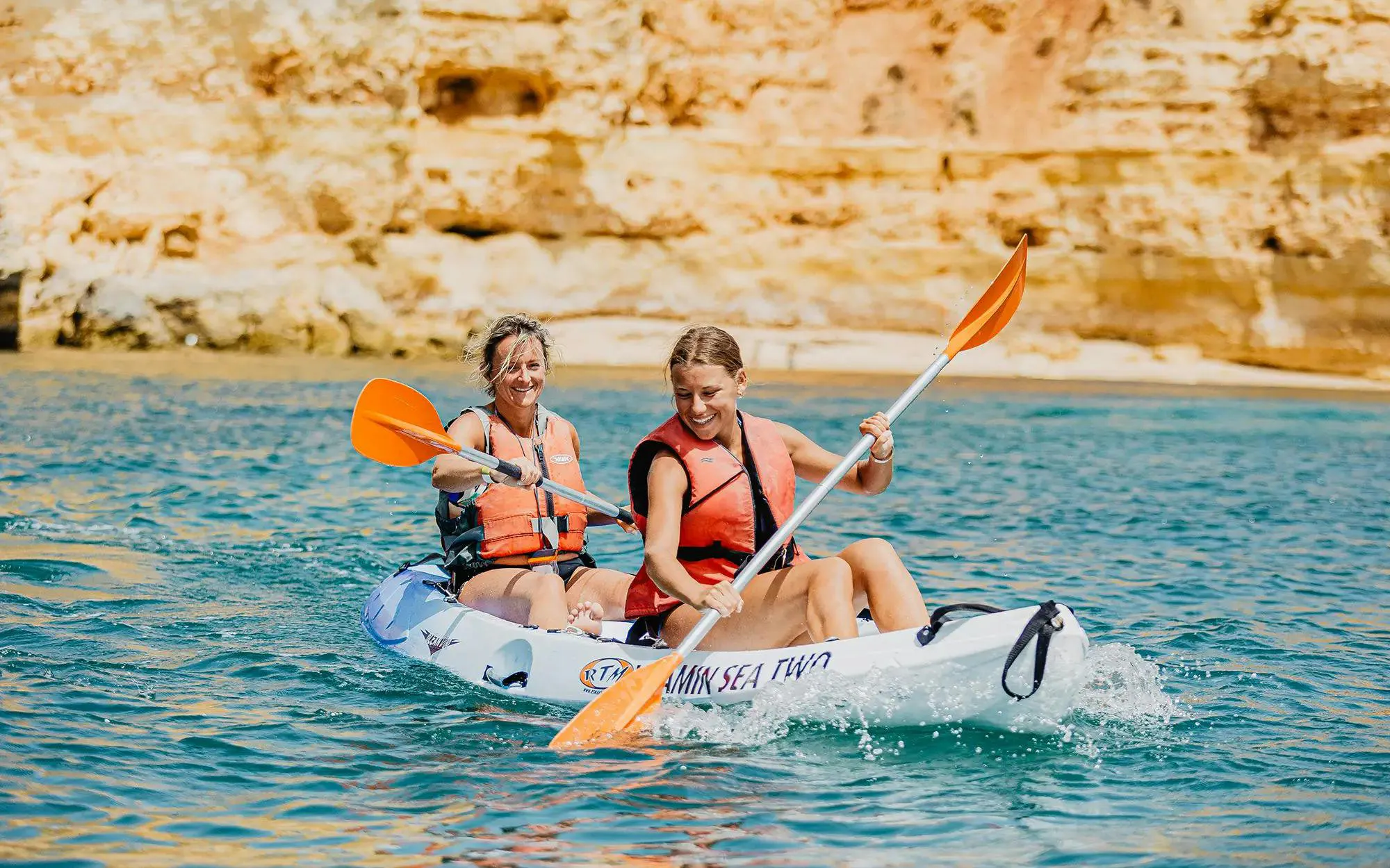 Kayakers paddling near cliffs on Ponta da Piedade Algarve tour.