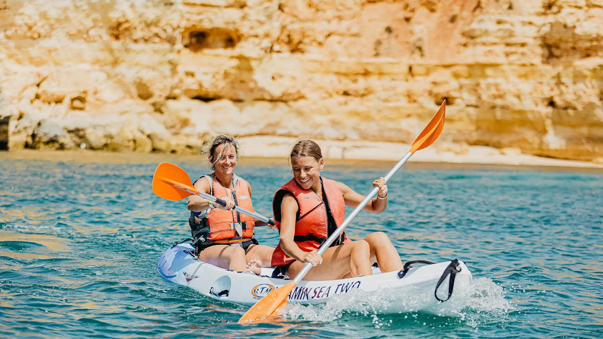 Kayakers paddling near cliffs on Ponta da Piedade Algarve tour.