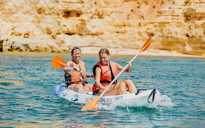 Kayakers paddling near cliffs on Ponta da Piedade Algarve tour.