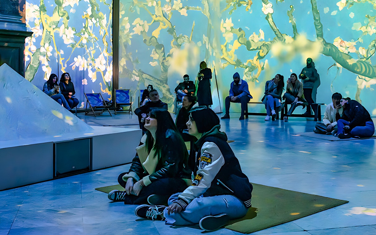 Guests viewing Van Gogh projections at London exhibition.