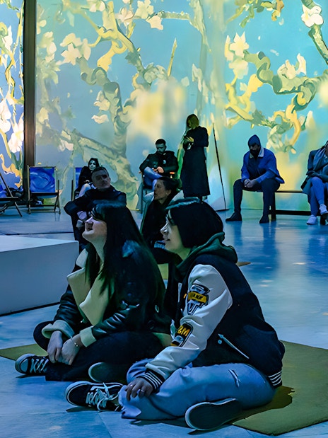 Guests viewing Van Gogh projections at London exhibition.