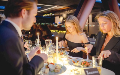 Guests dining on a candlelit dinner cruise in Stavanger.