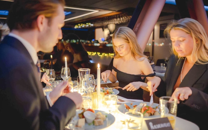 Guests dining on a candlelit dinner cruise in Stavanger.