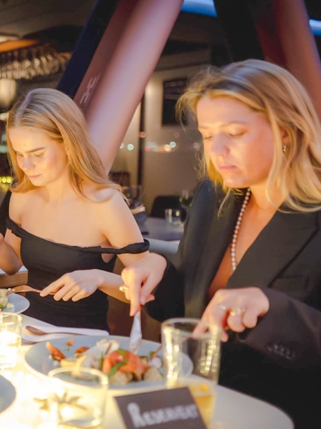 Guests dining on a candlelit dinner cruise in Stavanger.