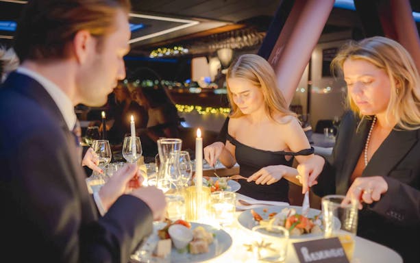 Guests dining on a candlelit dinner cruise in Stavanger.