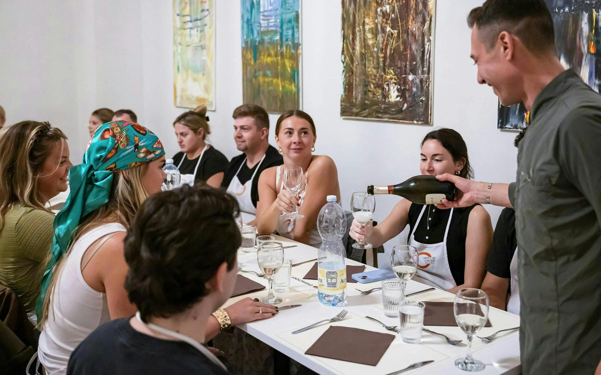 Small group enjoying wine at a cooking class in Florence.