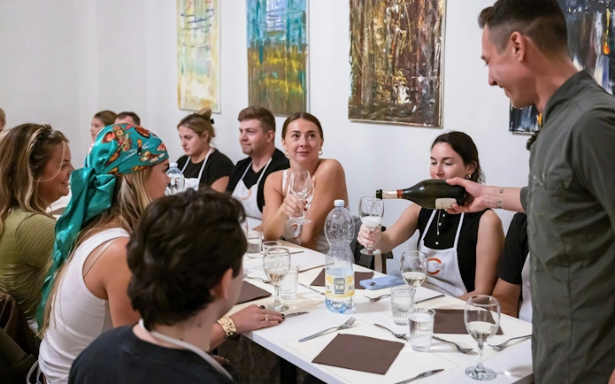 Small group enjoying wine at a cooking class in Florence.