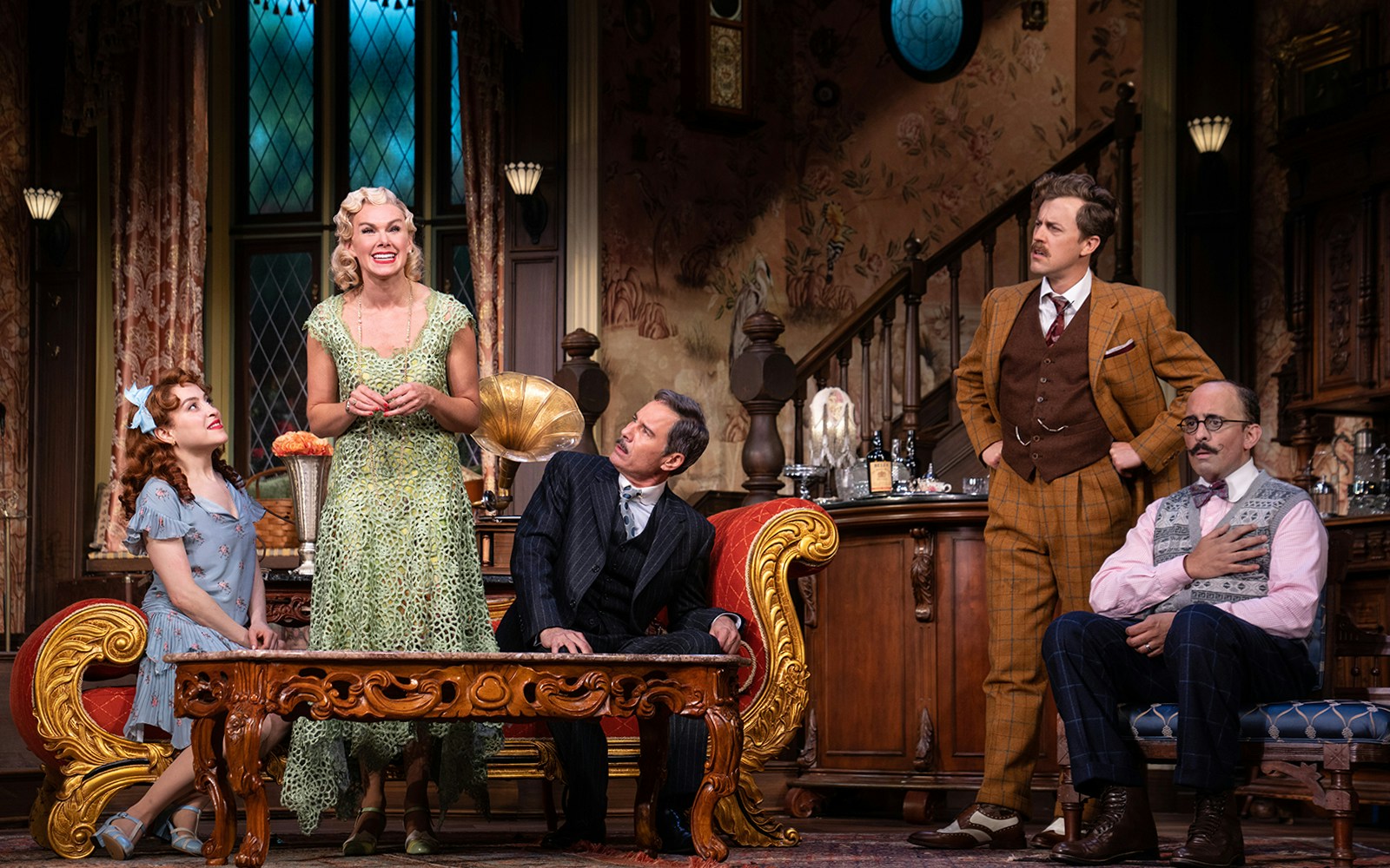 Actors performing a scene in a vintage living room setting for "The Cottage" play.