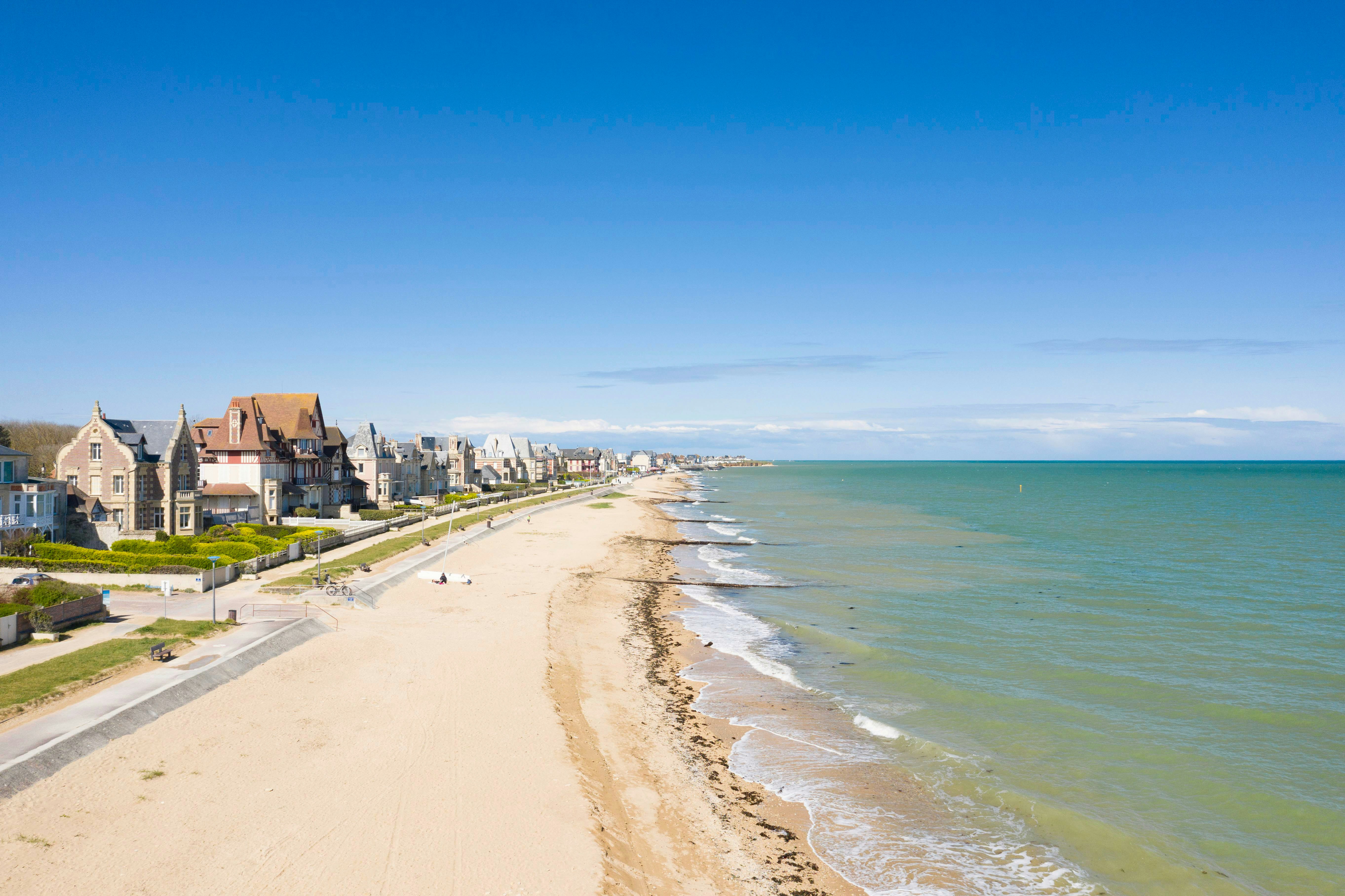 Aerial view of Sword Beach coastline with historic buildings in Normandy, France.