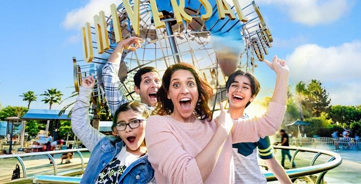Family taking a selfie in front of the Universal globe at Universal Studios, Los Angeles.