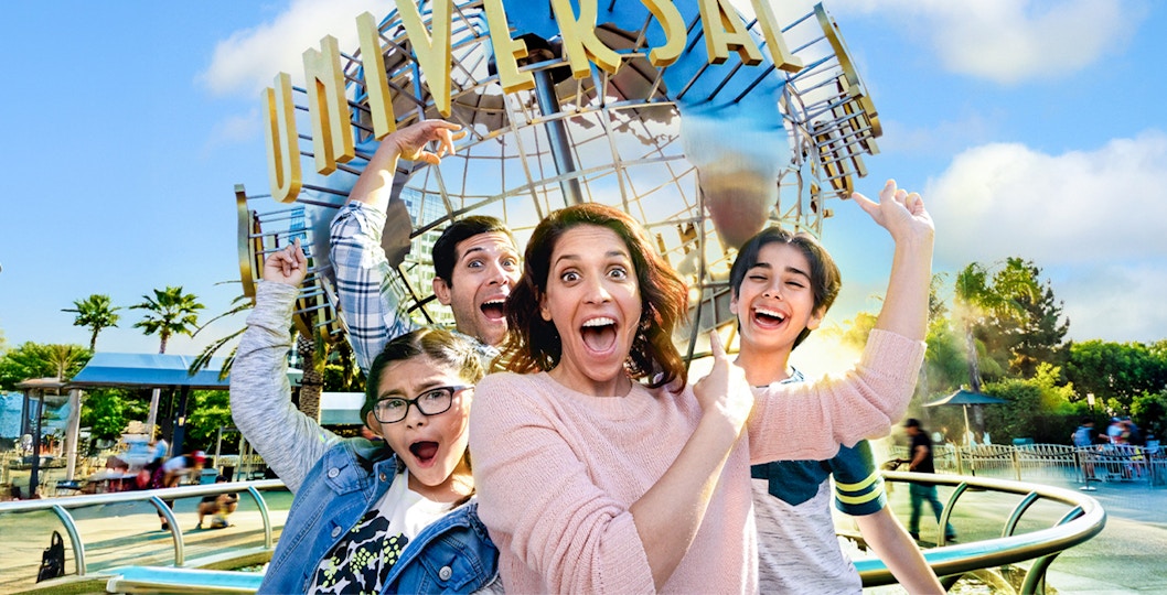 Family taking a selfie in front of the Universal globe at Universal Studios, Los Angeles.
