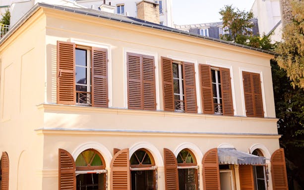 Musée de la Vie romantique facade with brown shutters, Paris, France.