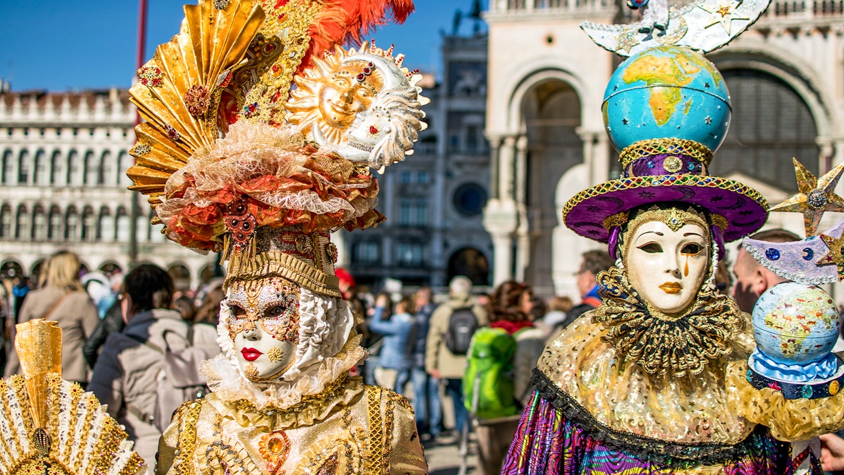Venice Carnival participants in traditional masks and costumes, Italy.