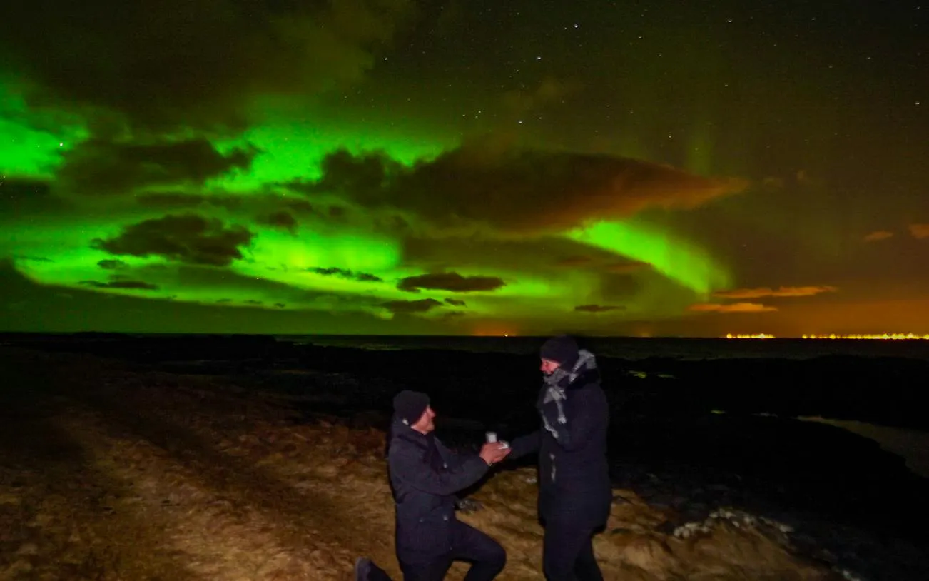 Couple under Northern Lights during Super Jeep tour, Reykjavik.